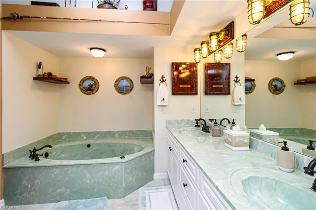 a bathroom with a granite countertop sink a toilet and a mirror