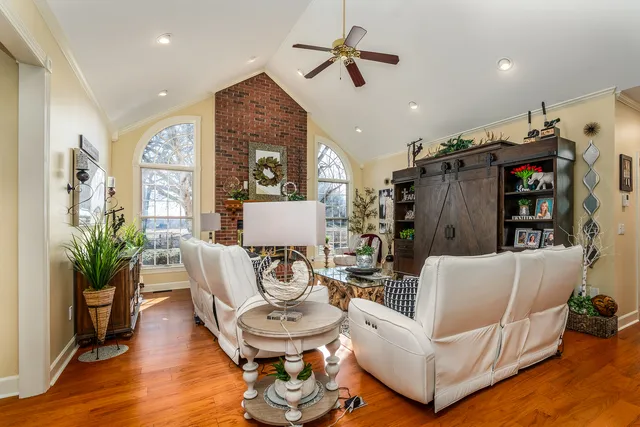 a living room with furniture fireplace and a book shelf