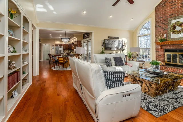 a kitchen with stainless steel appliances granite countertop a refrigerator a sink and wooden cabinets