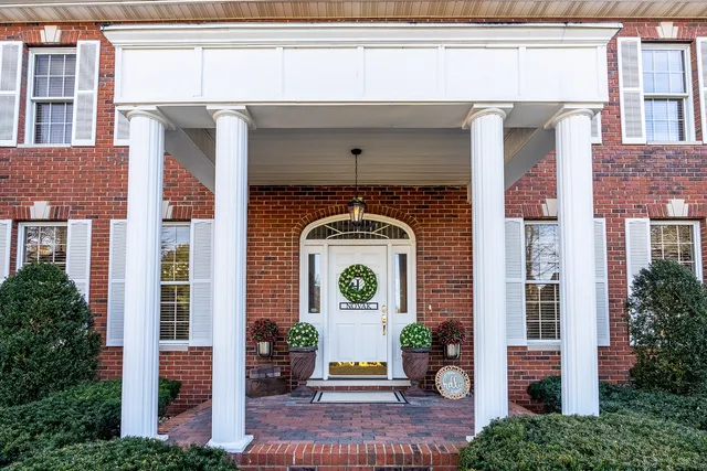 a view of hall way with furniture and wooden floor
