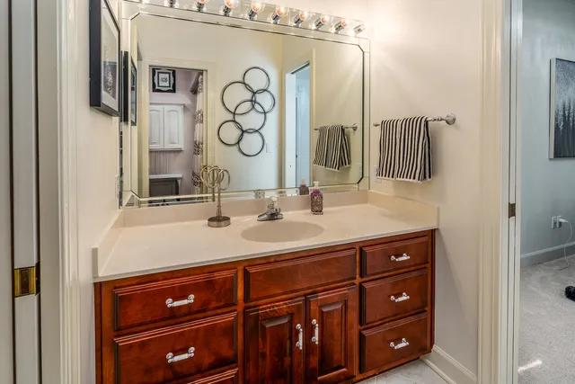 a view of a big house with a big yard plants and large trees