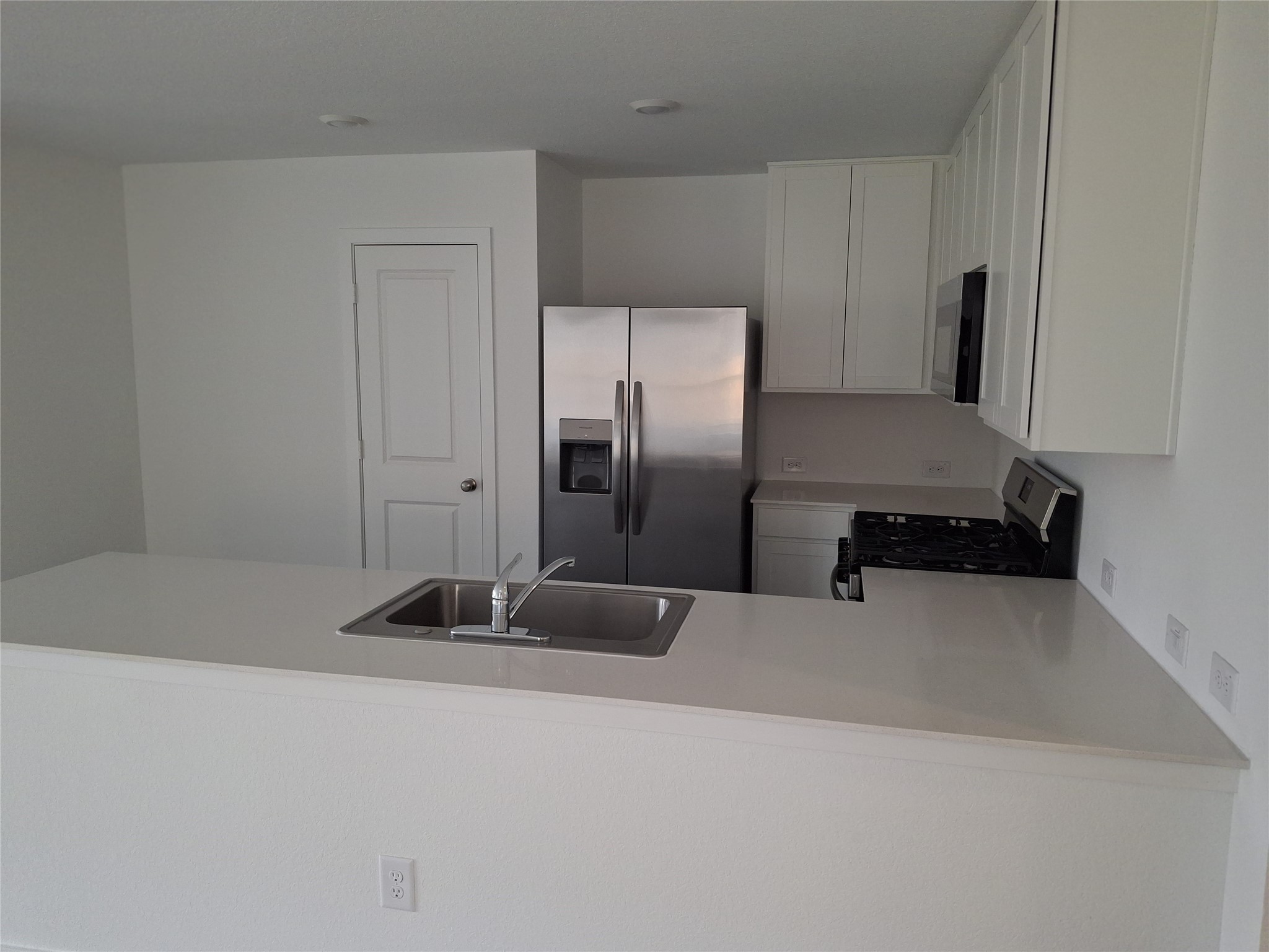 16126 Rustic Prairie Drive Grand Prairie, TX 75050 - Photo 11 of 17 a kitchen with a refrigerator and a sink