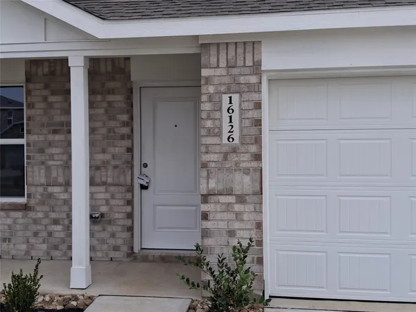 a front view of a house with white walls