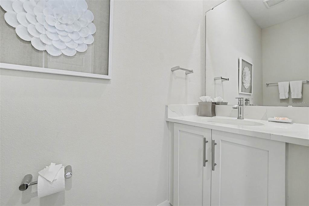 7841 Spectrum Drive Reunion, FL 34747 - Photo 11 of 30 a bathroom with a sink and a mirror