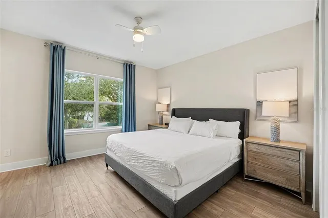 a bedroom with a large bed and a window