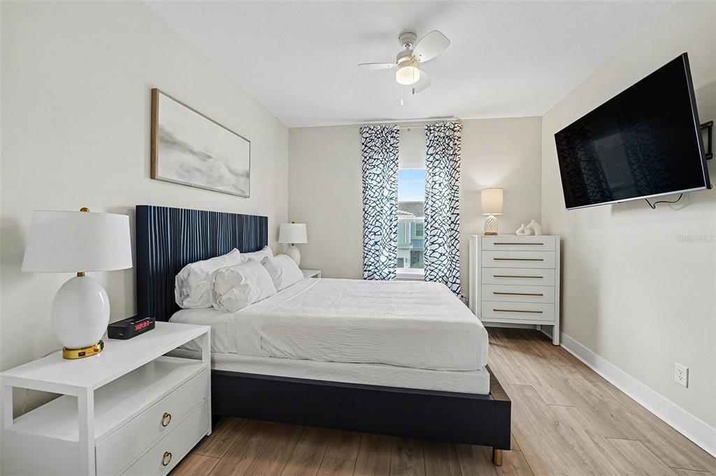 7841 Spectrum Drive Reunion, FL 34747 - Photo 17 of 30 a bedroom with a bed and a flat screen tv