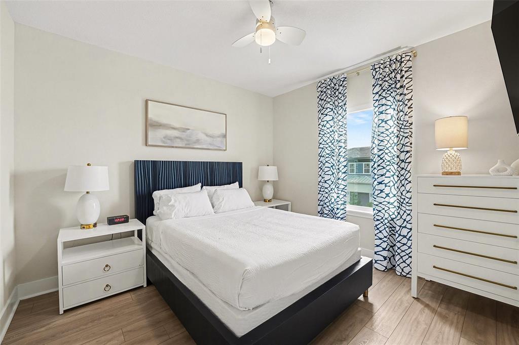 7841 Spectrum Drive Reunion, FL 34747 - Photo 18 of 30 a bedroom with a bed and a night stand