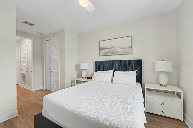 a bedroom with a bed and a painting