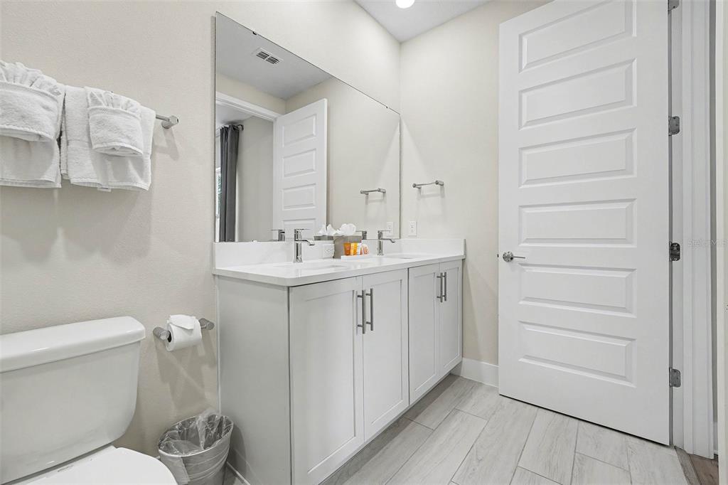 7841 Spectrum Drive Reunion, FL 34747 - Photo 20 of 30 a bathroom with a toilet sink and mirror
