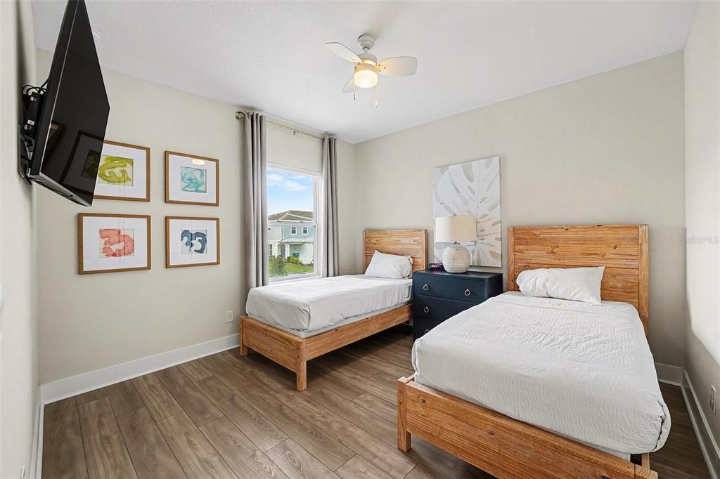 7841 Spectrum Drive Reunion, FL 34747 - Photo 22 of 30 a bedroom with two beds and a chandelier