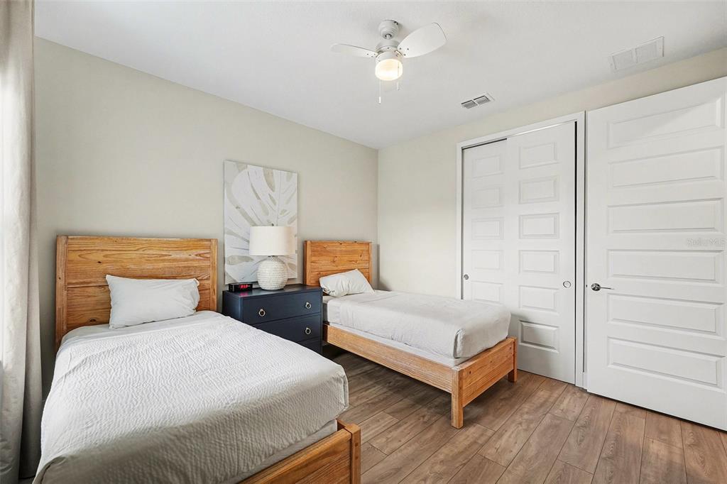 7841 Spectrum Drive Reunion, FL 34747 - Photo 23 of 30 a bedroom with two beds and painting on the wall