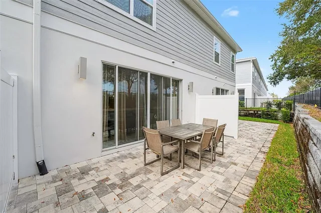 a view of a house with backyard and sitting area