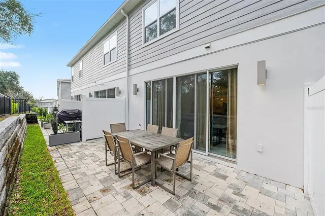 a view of a house with backyard and sitting area