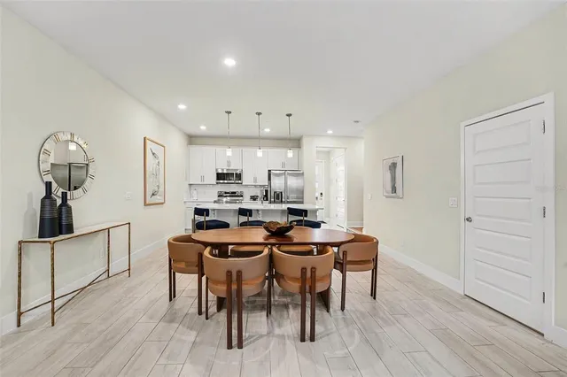 a view of a dining room with furniture and wooden floor