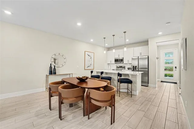 a view of a dining room with furniture and wooden floor