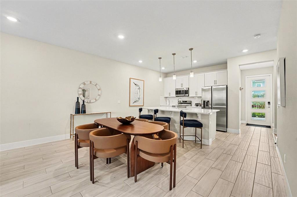 7841 Spectrum Drive Reunion, FL 34747 - Photo 6 of 30 a view of a dining room with furniture and wooden floor