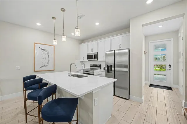 a kitchen with refrigerator cabinets and wooden floor