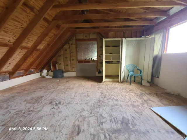 a view of empty room with furniture and a ceiling fan