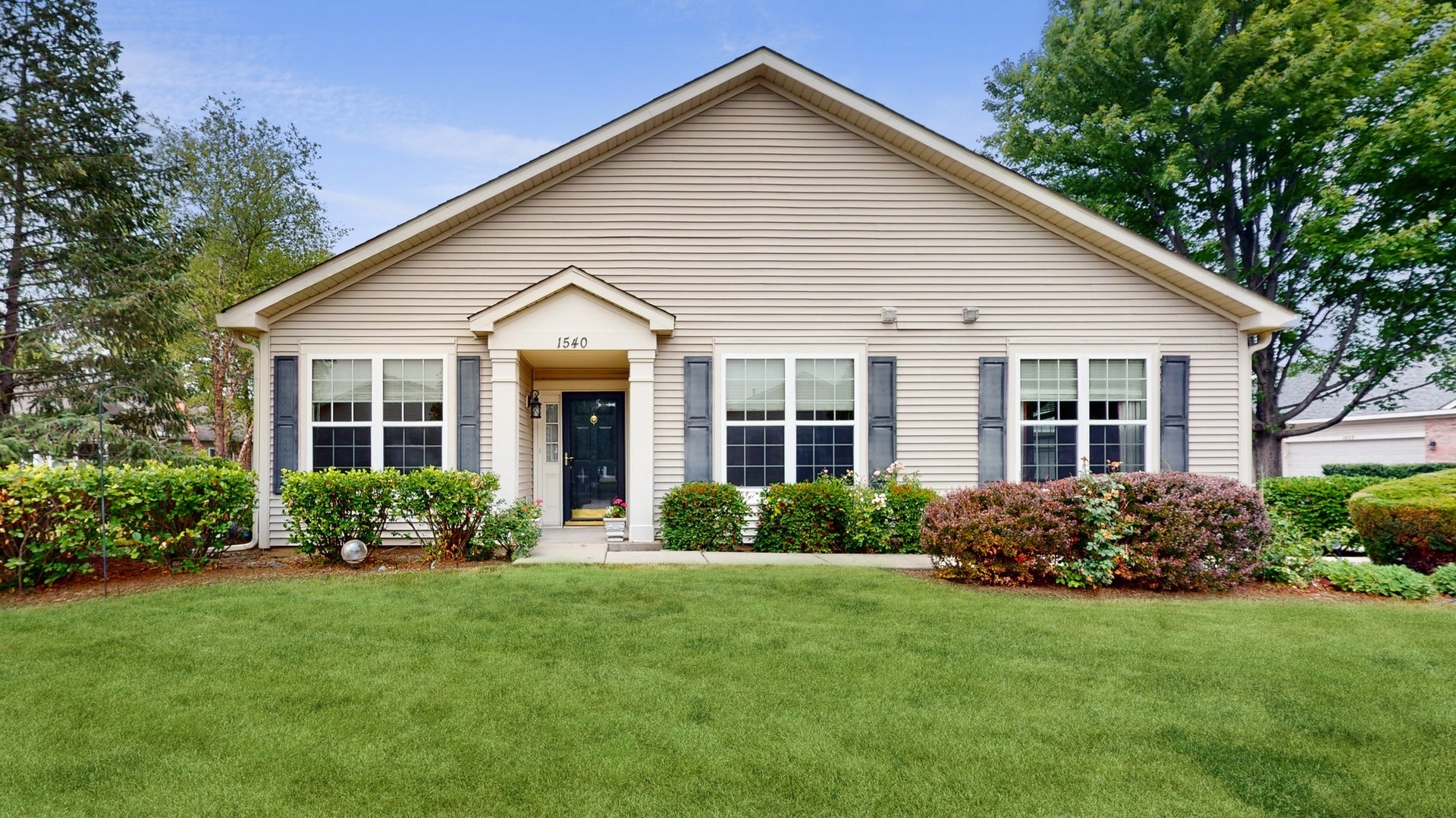 a view of a house with garden and yard