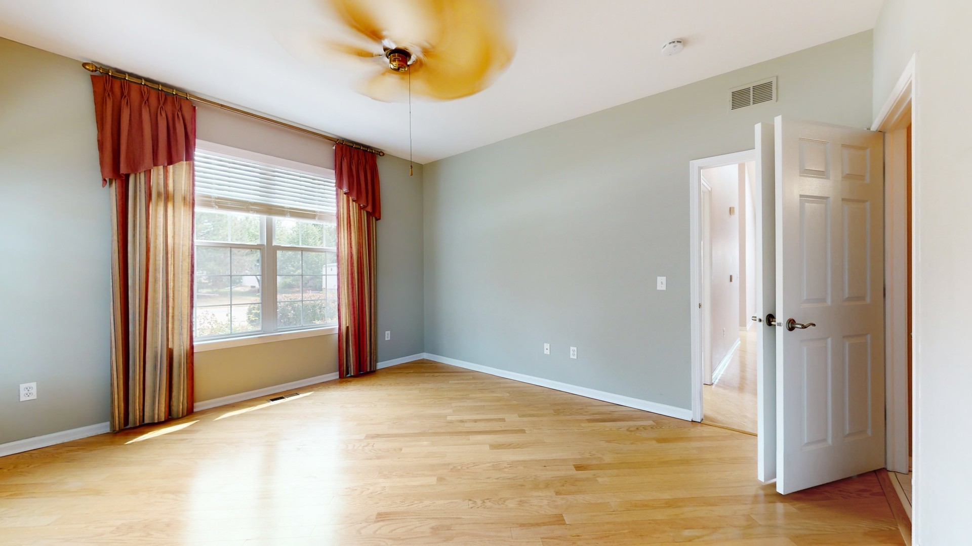 1540 Cadillac Circle Romeoville, IL 60446 - Photo 21 of 32 a view of an empty room with window and wooden floor