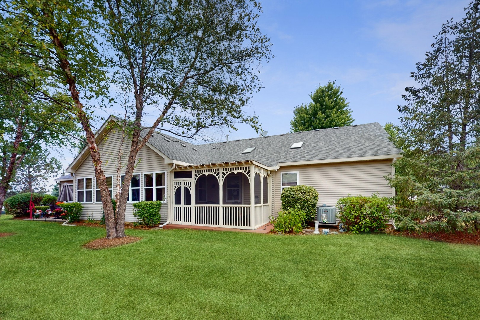 1540 Cadillac Circle Romeoville, IL 60446 - Photo 3 of 32 a front view of a house with a garden and trees