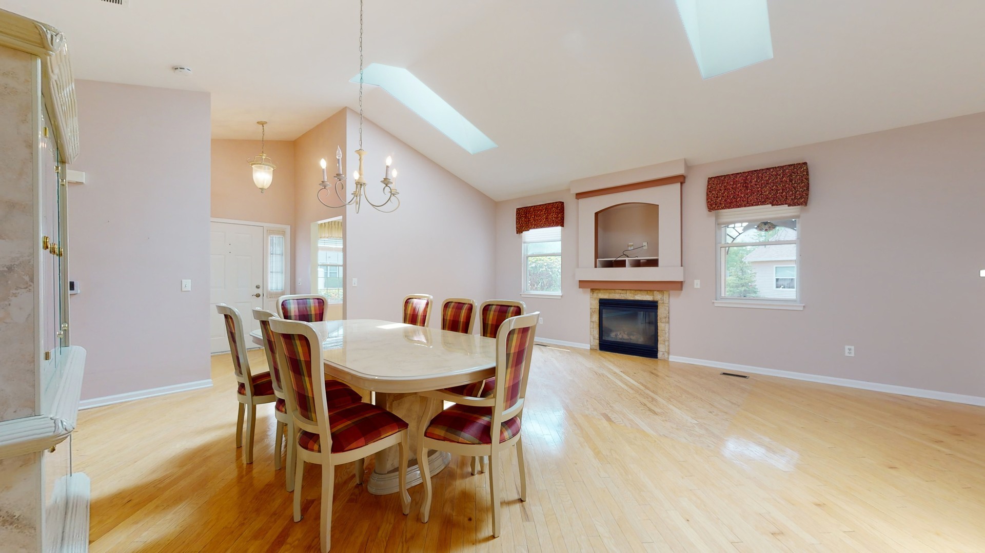1540 Cadillac Circle Romeoville, IL 60446 - Photo 4 of 32 a view of a dining room with furniture and a fireplace