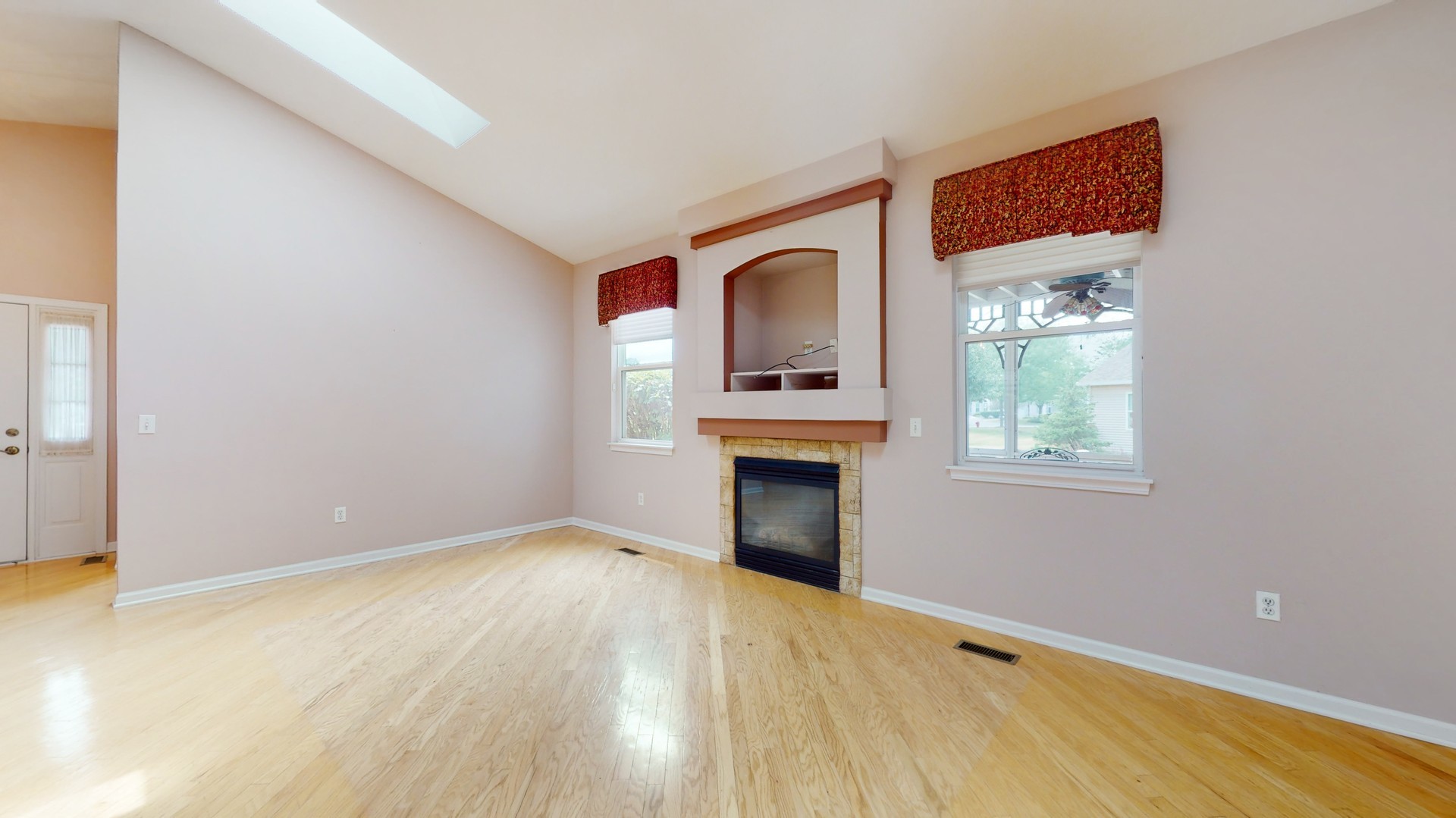 1540 Cadillac Circle Romeoville, IL 60446 - Photo 7 of 32 a view of an empty room with a fireplace and a window