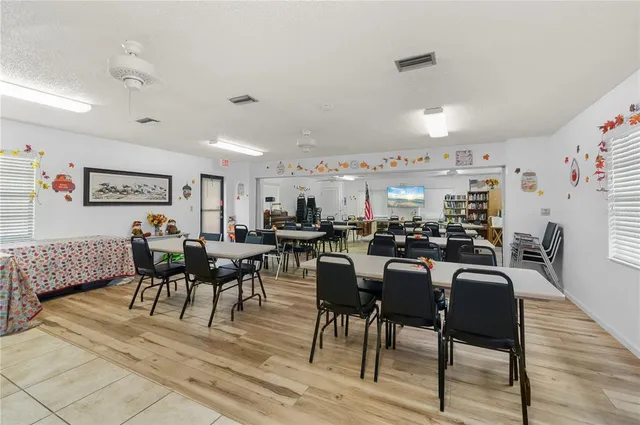 a hallway with a computer on a desk and chair
