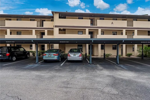 a couple of cars parked in front of a building