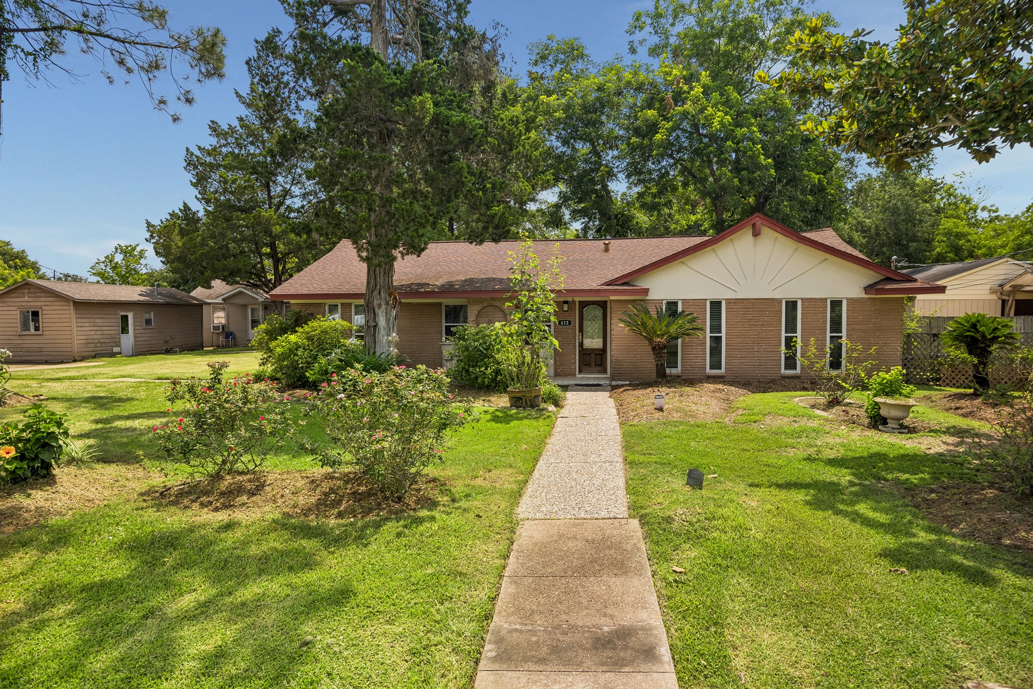 413 Mebane Lane Rosenberg, TX 77471 - Photo 1 of 30 Welcome to this charming single-story home with a dedicated path leading to the front door. The front yard features mature trees, lush greenery, and well-maintained landscaping, creating a serene and inviting atmosphere.