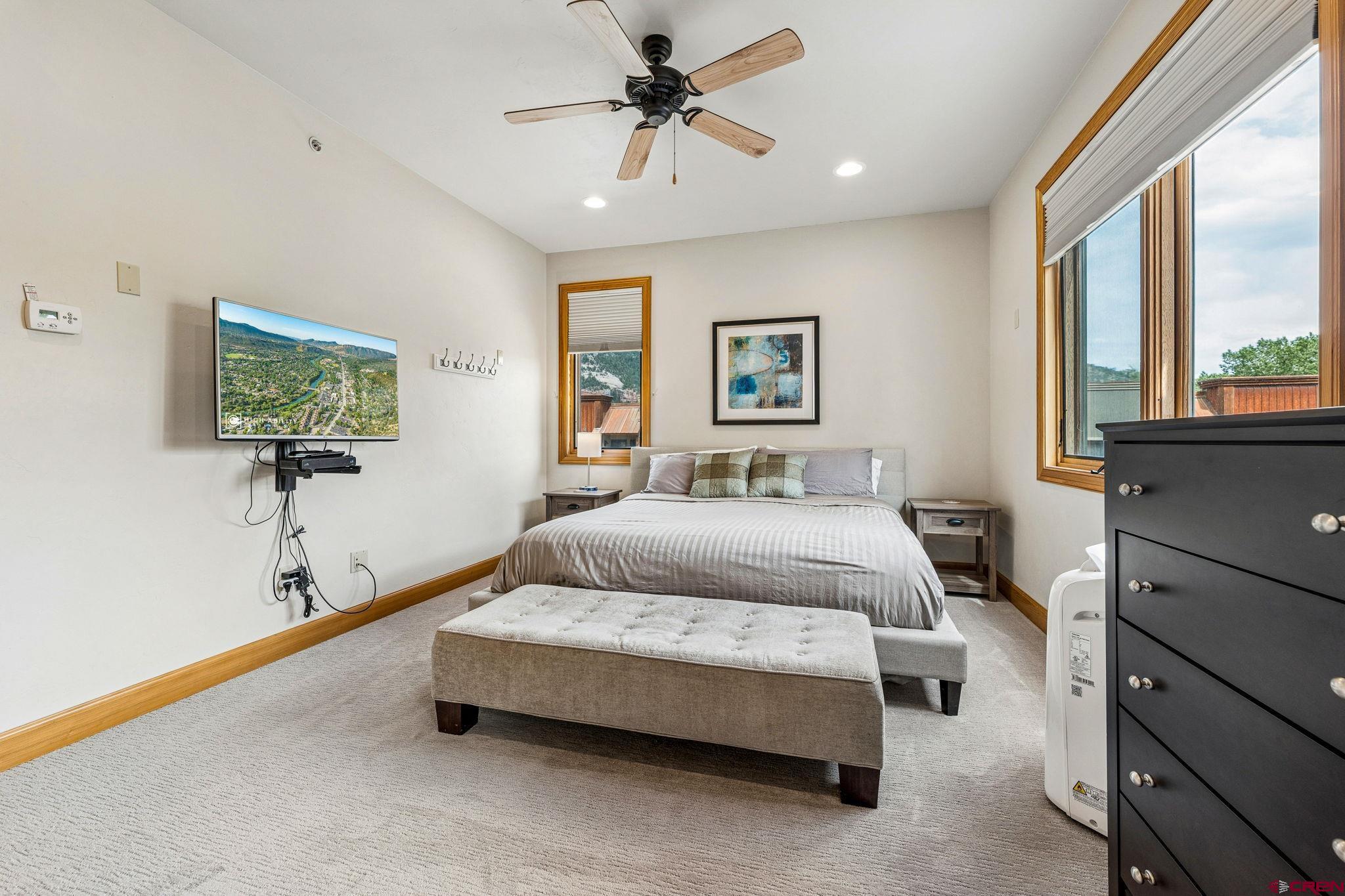 1422 Animas View Drive, Unit 55 Durango, CO 81301 - Photo 14 of 44 a bedroom with a bed and a chandelier