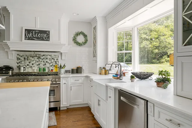 a kitchen with a sink cabinets and window