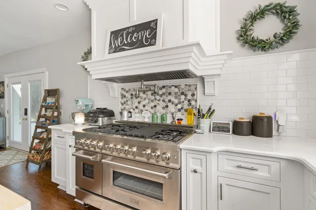 a kitchen with stainless steel appliances granite countertop a stove and a cabinets
