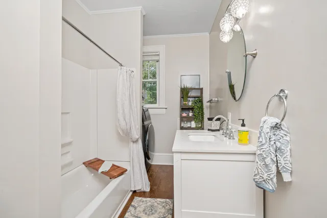 a bathroom with a sink mirror and vanity