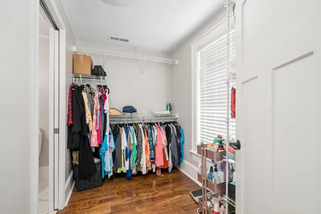 a view of walk in closet with clothes