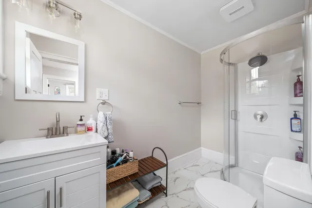 a bathroom with a sink toilet and shower