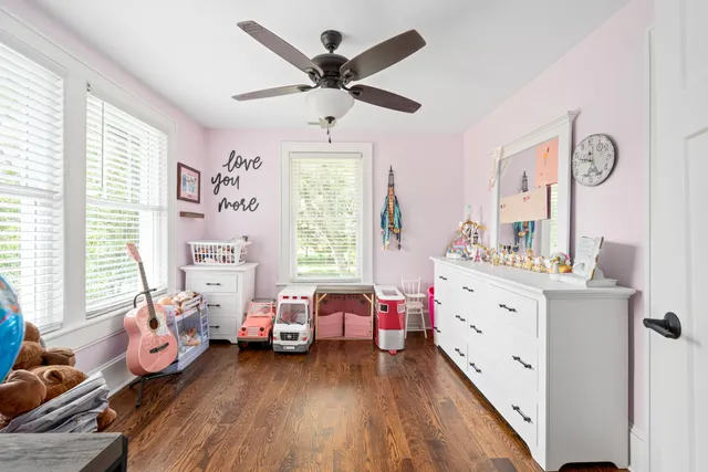 a bedroom with furniture and a large window