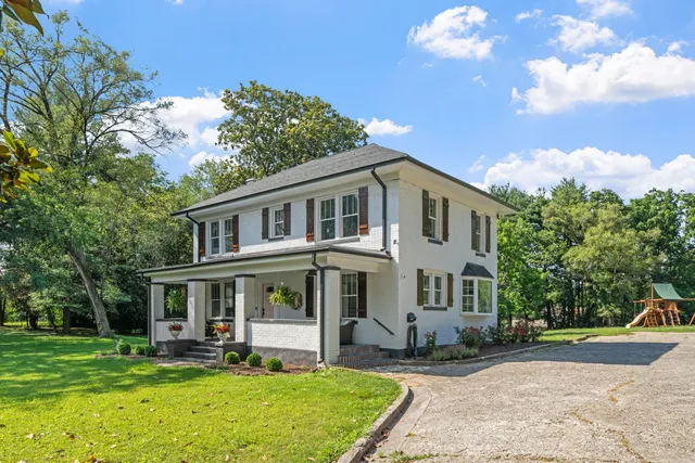 a front view of a house with garden and porch