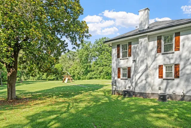 a view of a house with a backyard
