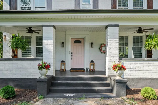 a front view of a house with outdoor seating