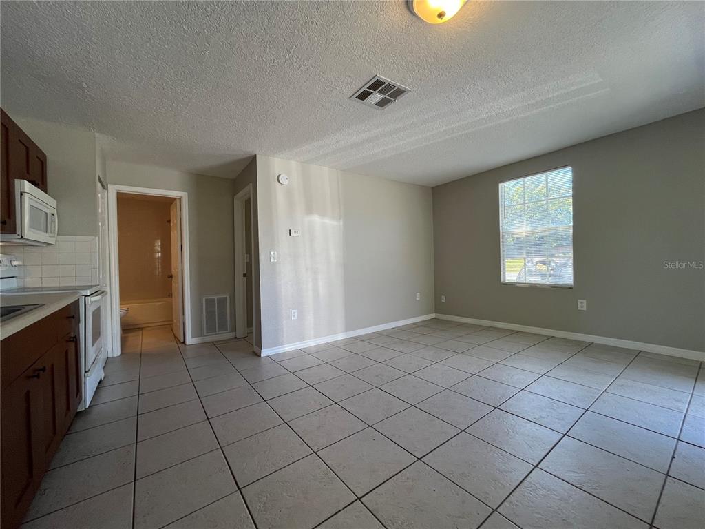 8546 Cameo Drive New Port Richey, FL 34654 - Photo 15 of 20 an empty room with windows and fireplace