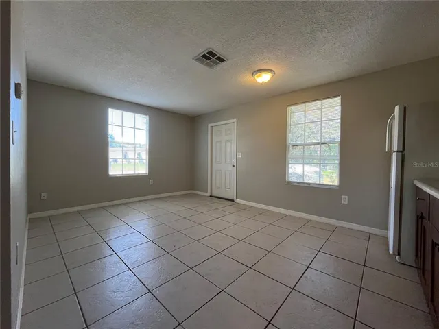 a view of kitchen with microwave and cabinets
