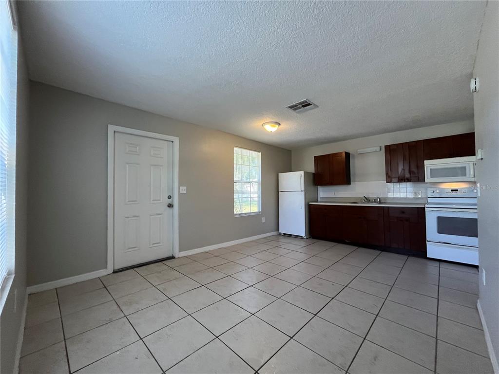 8546 Cameo Drive New Port Richey, FL 34654 - Photo 17 of 20 a view of kitchen with microwave and cabinets