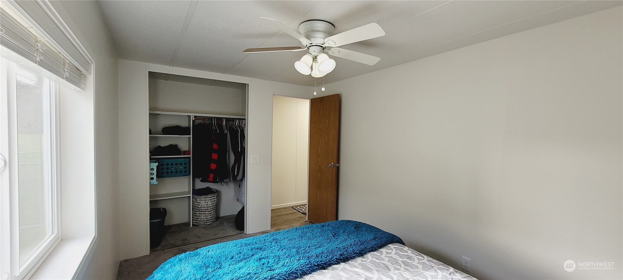 344 Atterberry Road Sequim, WA 98382 - Photo 23 of 40 a bedroom with a bed and a chandelier