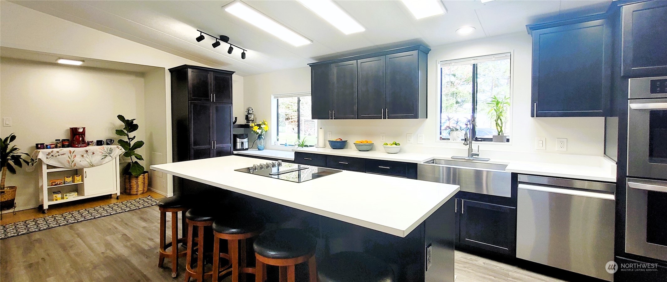 344 Atterberry Road Sequim, WA 98382 - Photo 3 of 40 a kitchen with a sink a stove a refrigerator and white cabinets