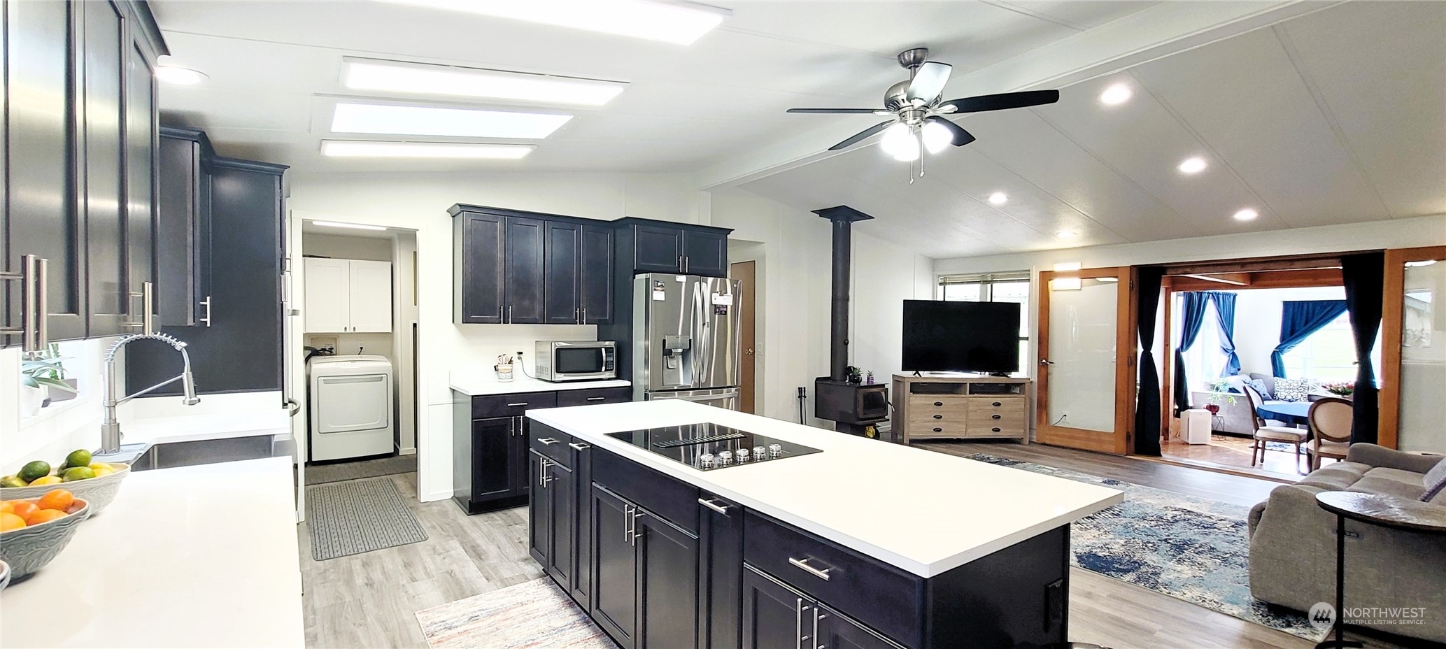 344 Atterberry Road Sequim, WA 98382 - Photo 7 of 40 a kitchen that has a lot of cabinets a sink and a refrigerator