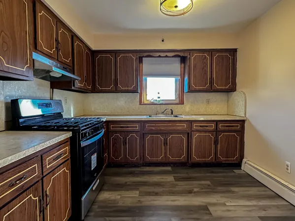 a kitchen with stainless steel appliances granite countertop a stove and a sink