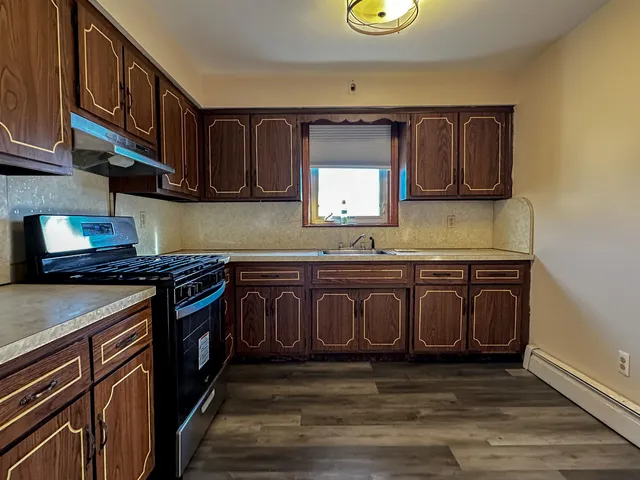 a kitchen with stainless steel appliances granite countertop a stove and a sink