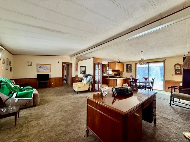a kitchen with stainless steel appliances kitchen island granite countertop a stove refrigerator and cabinets