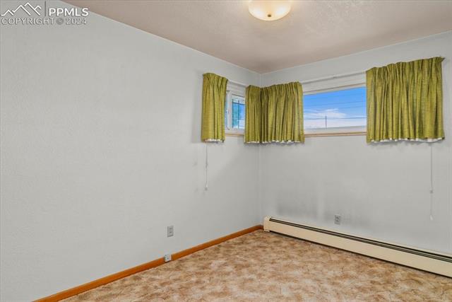28018 County Farm Road Pueblo, CO 81006 - Photo 6 of 50 Carpeted empty room with a baseboard heating unit